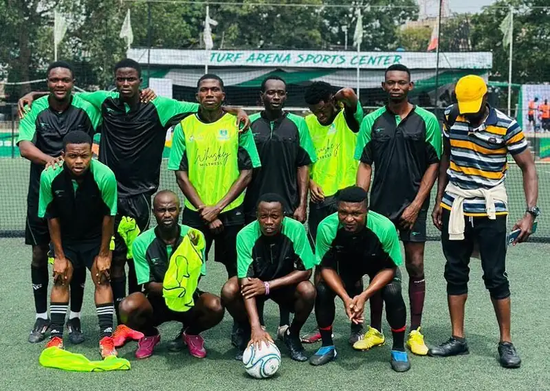 A community team lines up before a 5-a-side match